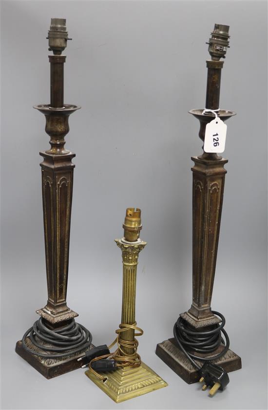 A pair of bronze lamps and a smaller brass lamp smaller height 60cm